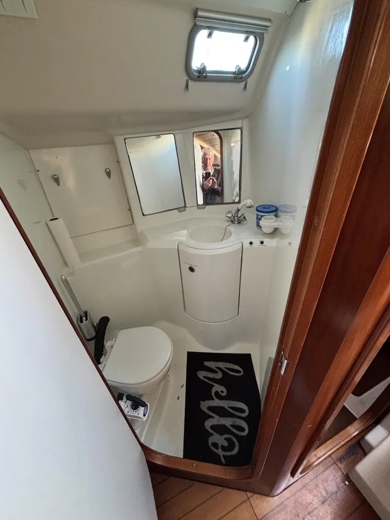 Slide: The Image of Bathroom interior of 1997 Beneteau Oceanis 351 sailboat with sink, toilet, and mirror. - 15