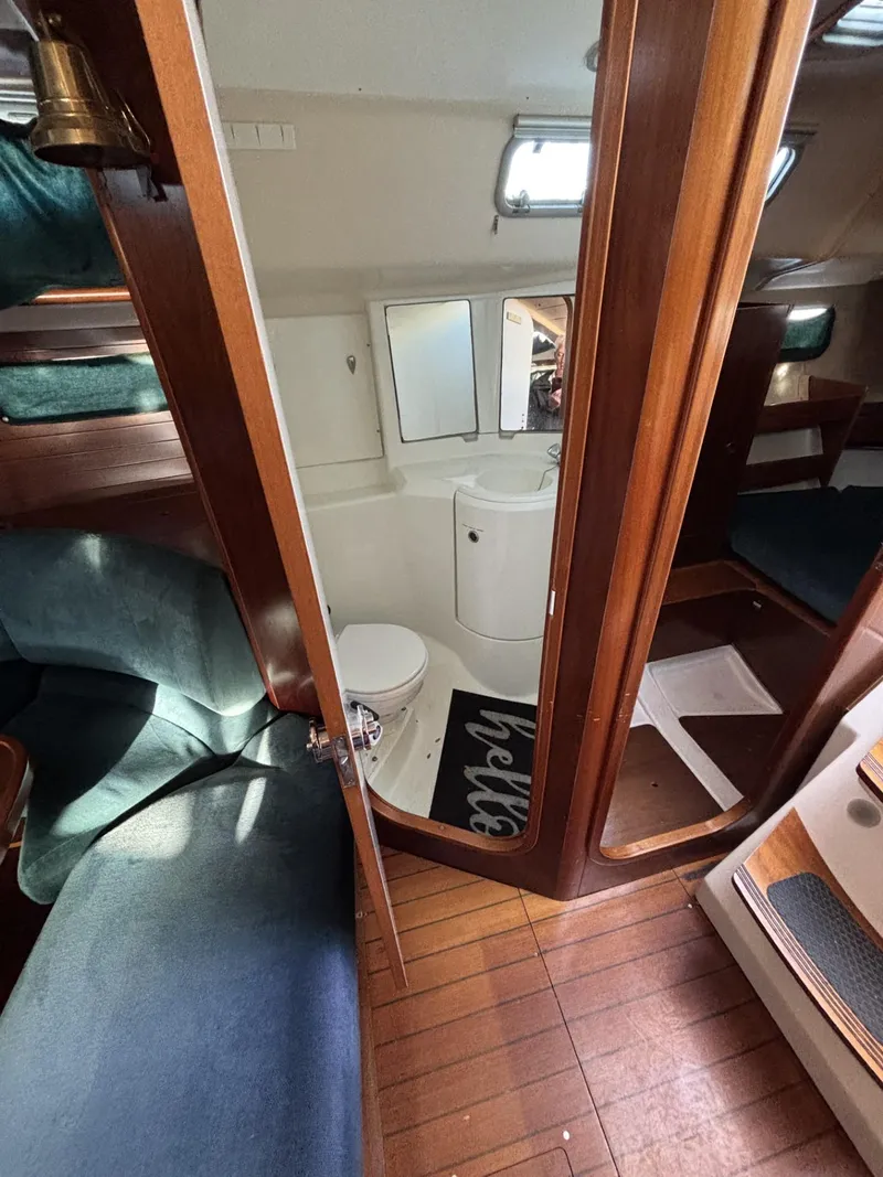 Slide: The Image of Interior of 1997 Beneteau Oceanis 351 sailboat, featuring cozy cabin and compact bathroom. - 16