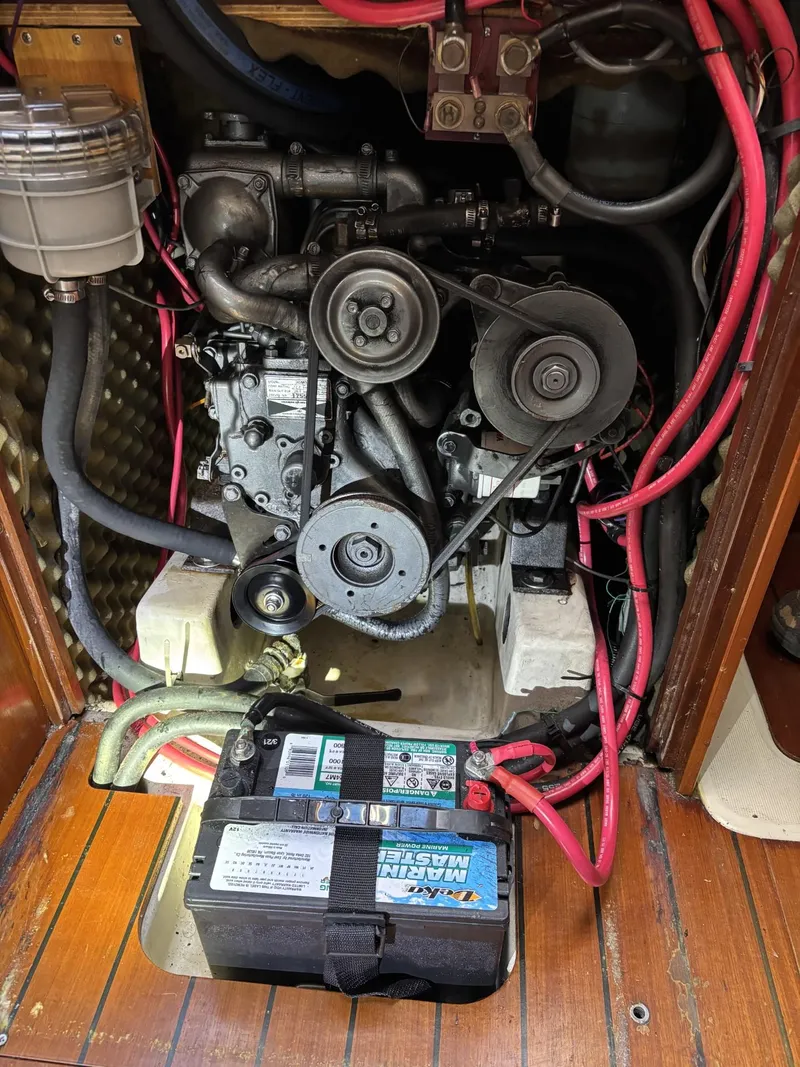 Slide: The Image of Engine compartment of a 1997 Beneteau Oceanis 351 sailboat, featuring wiring and battery. - 24