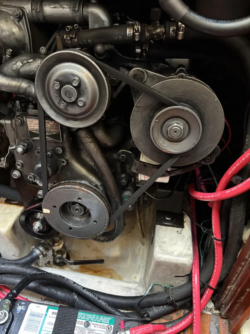 Slide: The Image of Engine compartment of a 1997 Beneteau Oceanis 351 sailboat, showing belts and wiring. - 25