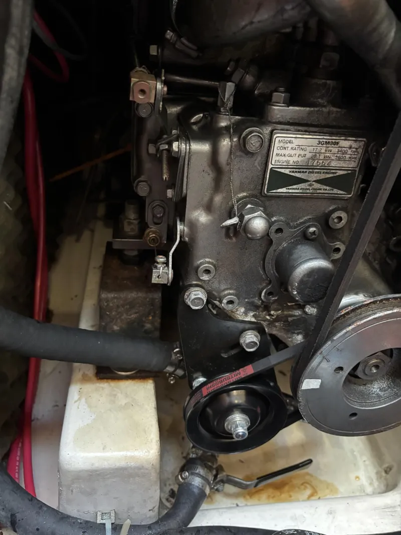 Slide: The Image of Engine compartment of a 1997 Beneteau Oceanis 351 sailboat, showing mechanical components and hoses. - 26