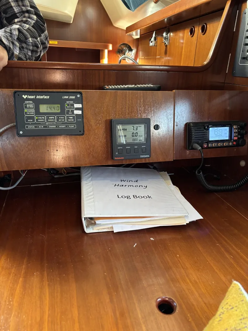 Slide: The Image of Interior of a 1997 Beneteau Oceanis 351 sailboat with navigation instruments and a log book. - 29