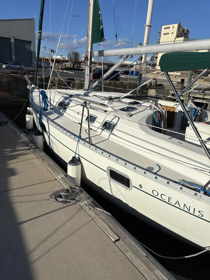 Slide: The Image of 1997 Beneteau Oceanis 351 sailboat docked at a marina on a sunny day. - 3