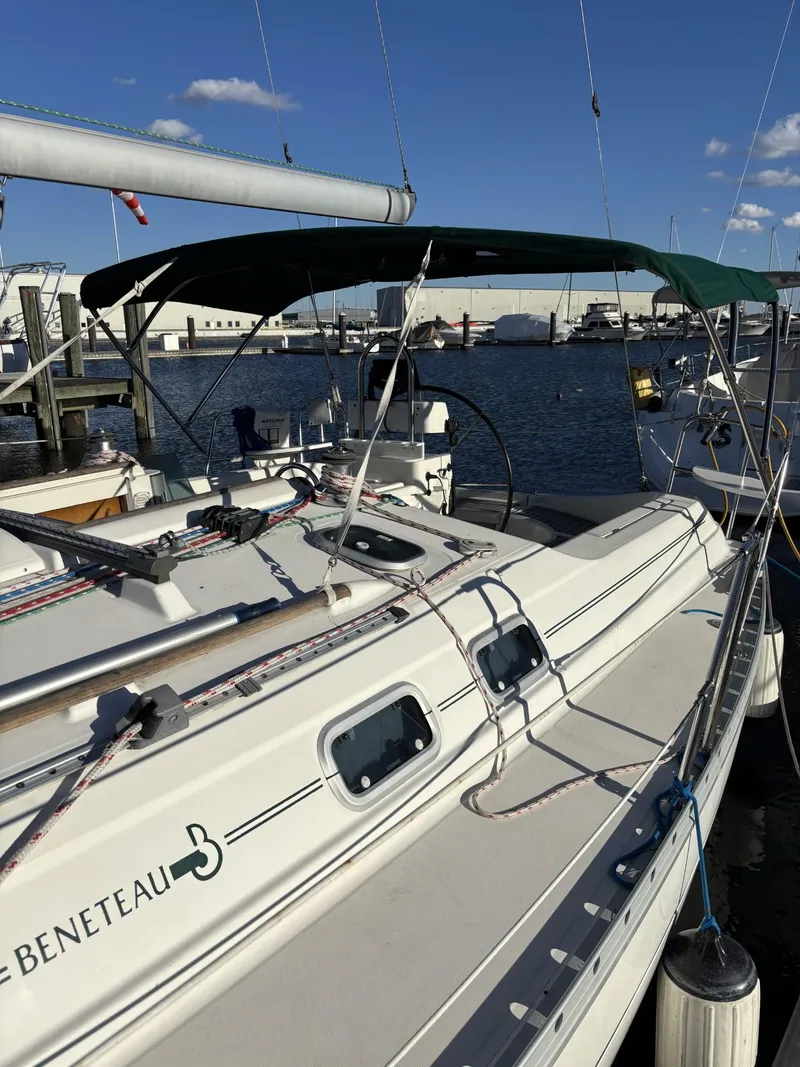 Slide: The Image of 1997 Beneteau Oceanis 351 sailboat docked at marina under clear blue sky. - 4