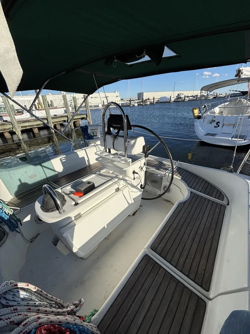 Slide: The Image of 1997 Beneteau Oceanis 351 sailboat cockpit with steering wheel, docked at marina. - 5