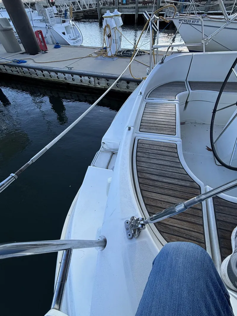 Slide: The Image of Cockpit view of a 1997 Beneteau Oceanis 351 sailboat docked at a marina. - 6