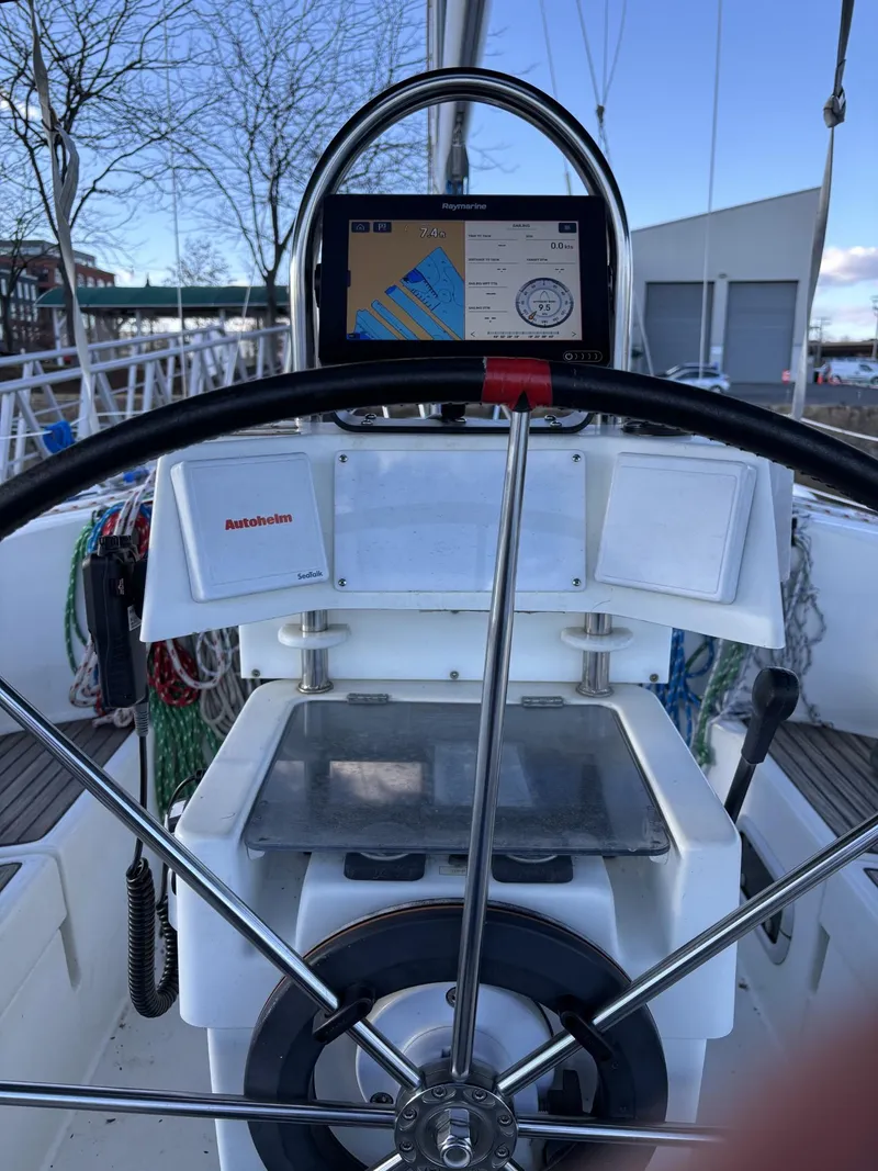 Slide: The Image of 1997 Beneteau Oceanis 351 sailboat helm with navigation display and steering wheel. - 8