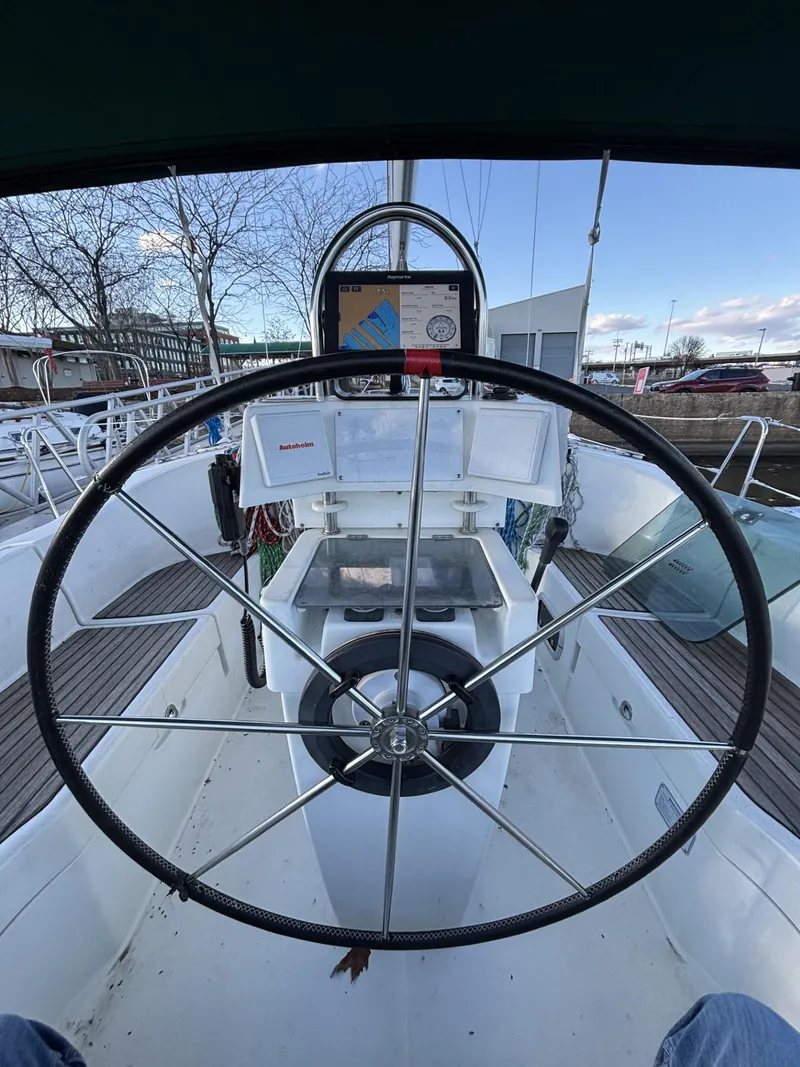 Slide: The Image of Cockpit view of 1997 Beneteau Oceanis 351 sailboat with steering wheel and navigation equipment. - 9
