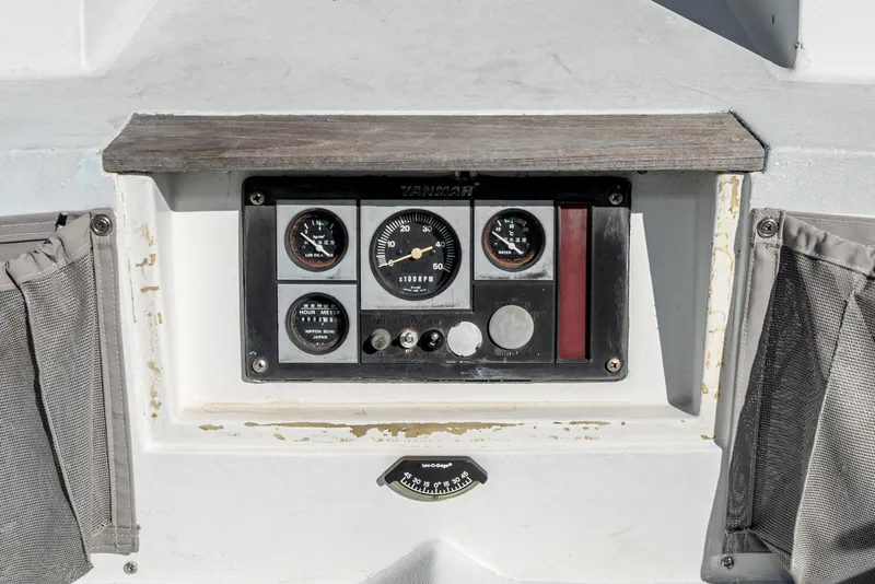 Slide: The Image of Control panel of a 1992 Tripp 47 boat with gauges and switches. - 22
