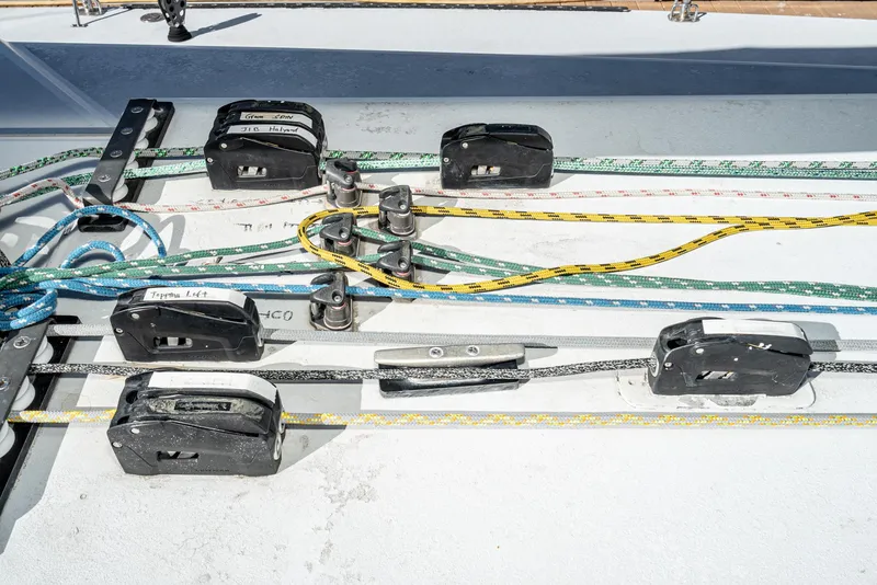 Slide: The Image of Sailing rigging on a 1992 Tripp 47 yacht, featuring colorful ropes and pulleys. - 26