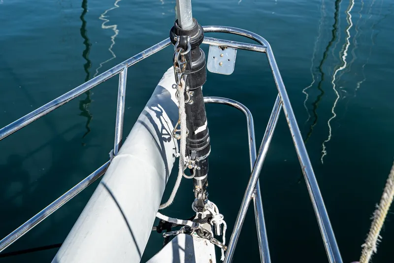 Slide: The Image of Bow of a 1992 Tripp 47 sailboat with stainless steel fittings and calm water reflection. - 30