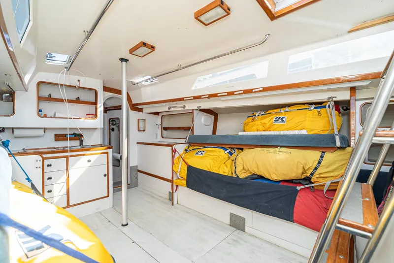 Slide: The Image of Interior of 1992 Tripp 47 sailboat with bunks, storage, and bright natural lighting. - 35