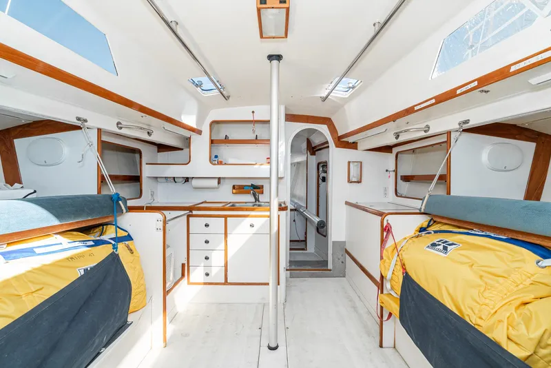 Slide: The Image of Interior of a 1992 Tripp 47 sailboat, featuring a spacious cabin with wooden accents. - 36
