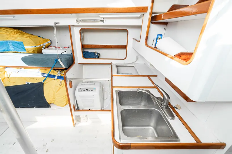 Slide: The Image of Interior of 1992 Tripp 47 sailboat with dual sinks and storage compartments. - 40
