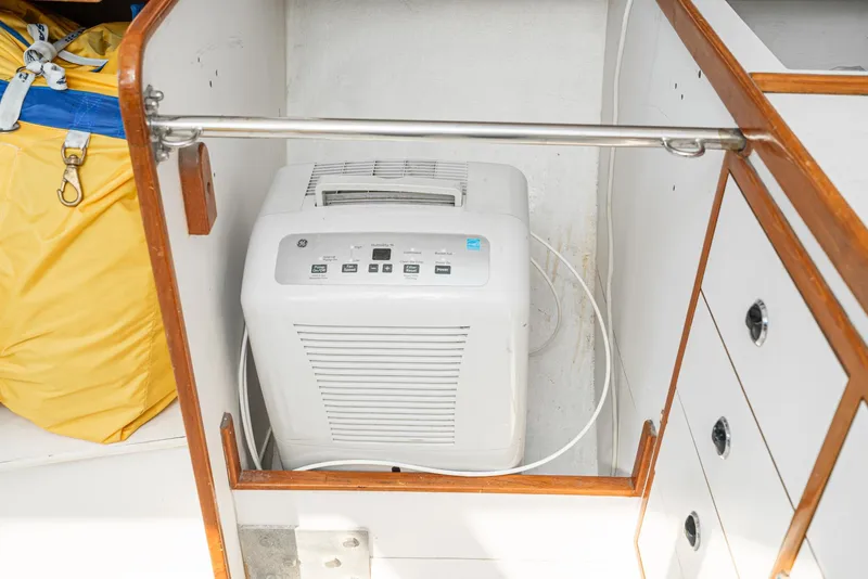 Slide: The Image of Dehumidifier inside a Tripp 47 sailboat, model year 1992, with wooden cabinetry. - 41