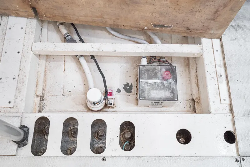 Slide: The Image of Bilge area of a 1992 Tripp 47 boat, showing pump and wiring components. - 44