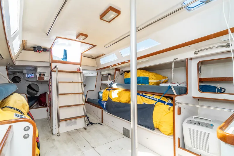 Slide: The Image of Interior of a 1992 Tripp 47 sailboat with cozy bunks and bright natural lighting. - 46