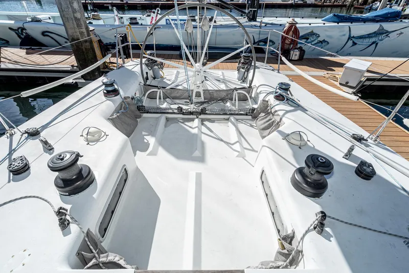 Slide: The Image of Cockpit of 1992 Tripp 47 sailboat with steering wheel and winches, docked at marina. - 8