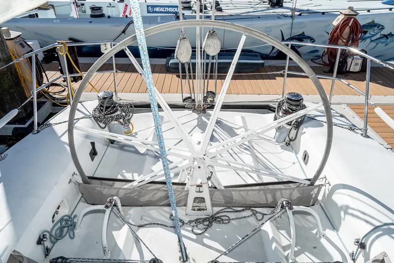 Slide: The Image of Sailboat cockpit with large wheel, Tripp 47 model, 1992, docked at marina. - 9