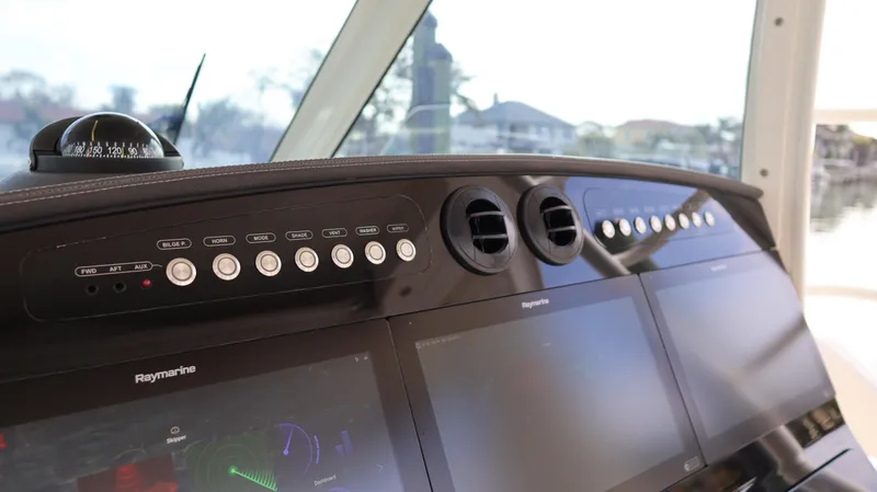Slide: The Image of 2018 Boston Whaler 420 Outrage dashboard with navigation controls and displays. - 23