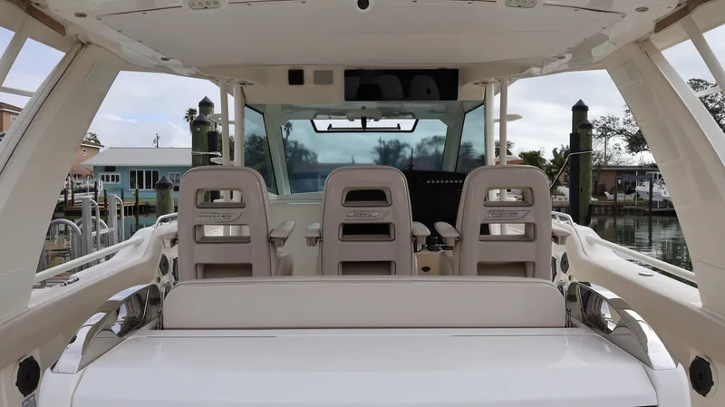 Slide: The Image of 2018 Boston Whaler 420 Outrage boat interior with helm seats and dashboard view. - 35