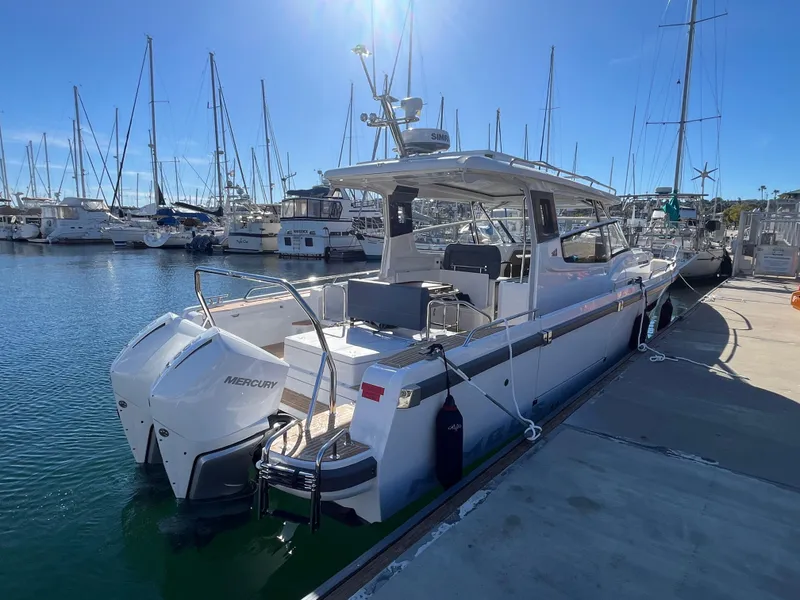 Slide: The Image of Nimbus W11 #46 2025 model boat docked in a marina under clear blue skies. - 0