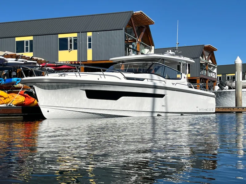 Slide: The Image of Nimbus W11 #46 2025 boat docked at marina, modern design, sunny day. - 1