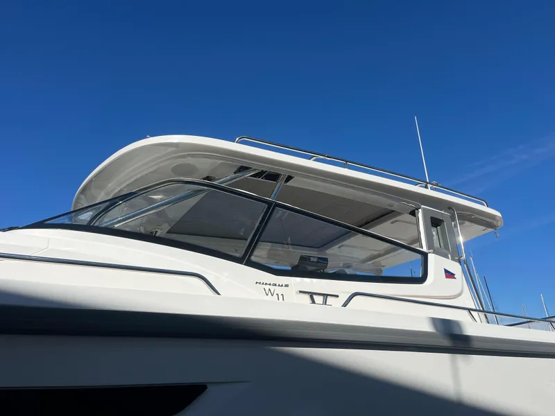 Slide: The Image of Nimbus W11 #46 boat, 2025 model, under clear blue sky. - 15