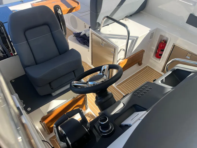 Slide: The Image of Nimbus W11 #46 2025 boat cockpit with steering wheel and control panel. - 26