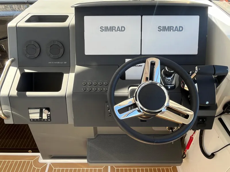 Slide: The Image of Nimbus W11 #46 2025 boat dashboard with dual Simrad displays and steering wheel. - 27
