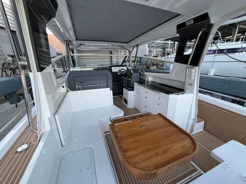 Slide: The Image of Interior of 2025 Nimbus W11 #46 boat with modern seating and wooden table. - 9