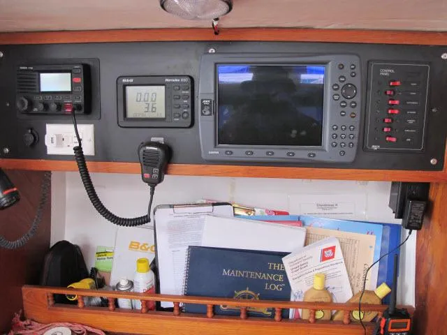 Slide: The Image of Control panel of a 1985 Santa Cruz 70 yacht with navigation equipment and maintenance log. - 16