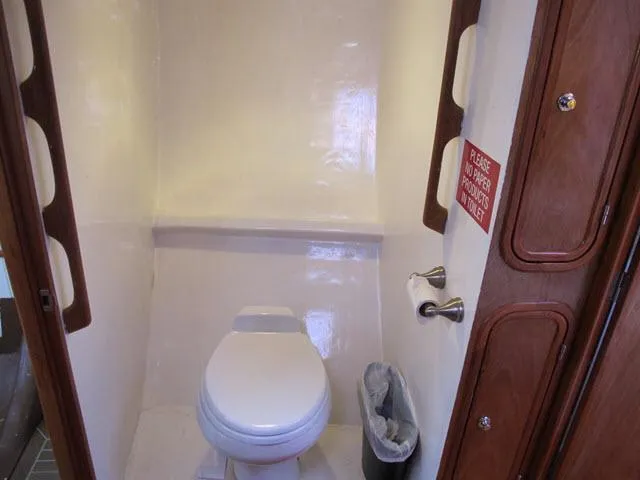Slide: The Image of Compact bathroom in 1985 Santa Cruz 70 yacht with toilet and wooden accents. - 23