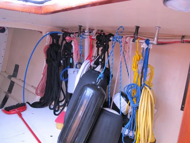 Slide: The Image of Colorful ropes and fenders stored inside a 1985 Santa Cruz 70 sailboat. - 26