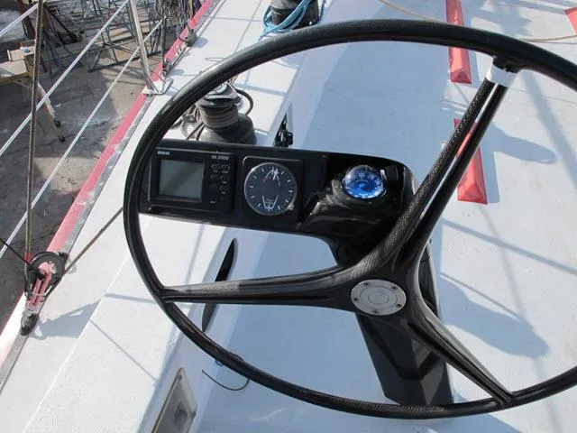 Slide: The Image of Steering wheel of a 1985 Santa Cruz 70 sailboat with navigation instruments. - 33