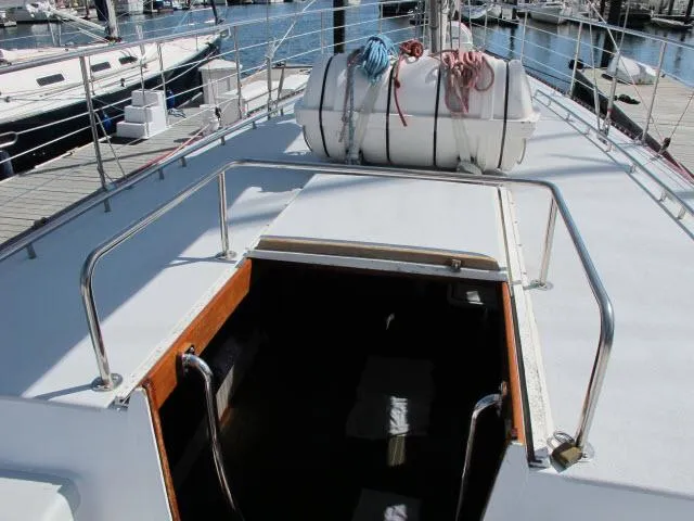 Slide: The Image of 1985 Santa Cruz 70 sailboat deck with open hatch and lifeboat. - 39