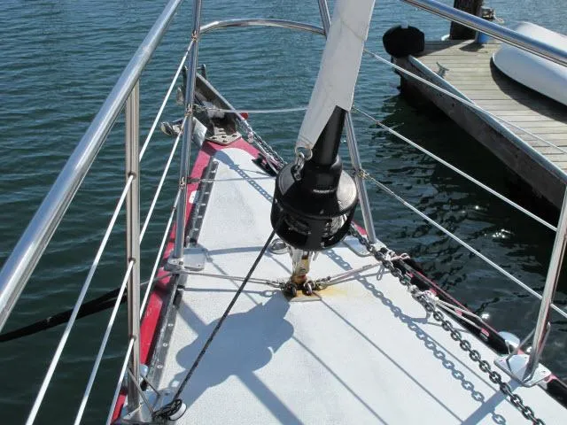 Slide: The Image of 1985 Santa Cruz 70 sailboat bow with rigging and dock view. - 46