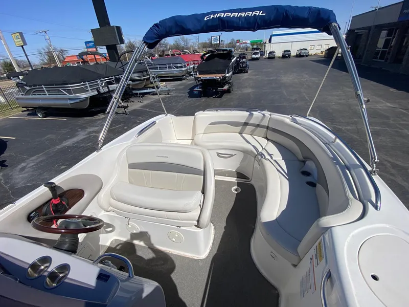 Slide: The Image of 2007 Chaparral Sunesta 252 boat interior with seating and steering wheel, parked outdoors. - 7