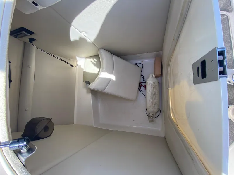 Slide: The Image of 2007 Chaparral Sunesta 252 boat storage compartment with seat cushion and accessories. - 9