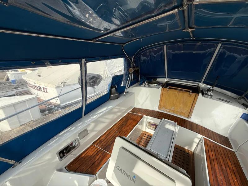 Slide: The Image of 1986 Beneteau Idylle 15.50 cockpit with blue canopy and wooden flooring. - 20