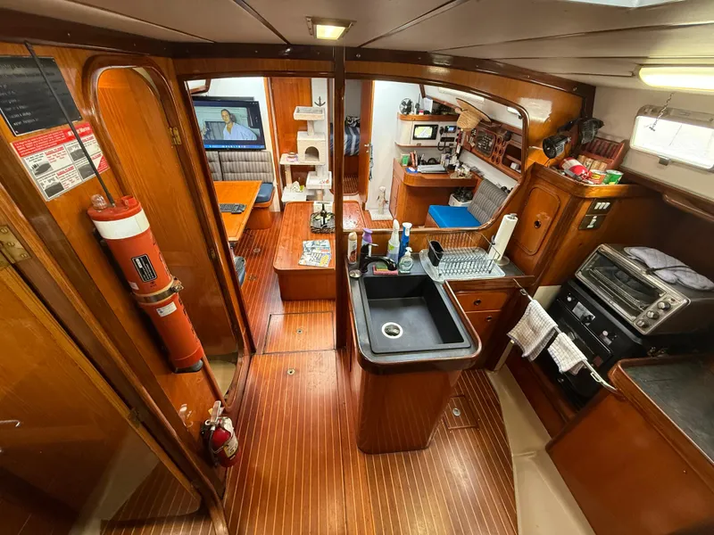 Slide: The Image of Interior of 1986 Beneteau Idylle 15.50 yacht with kitchen and living area. - 28