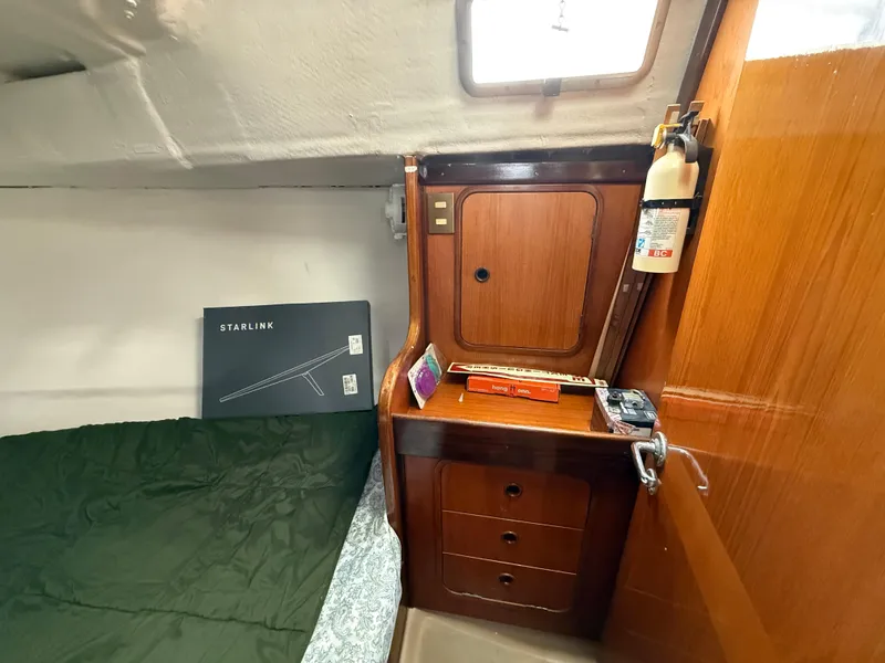 Slide: The Image of Cabin interior of 1986 Beneteau Idylle 15.50 with wooden cabinetry and Starlink box. - 34