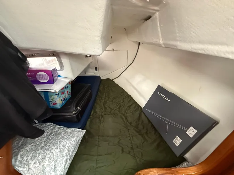 Slide: The Image of Cozy cabin interior of 1986 Beneteau Idylle 15.50 with bedding and storage items. - 35