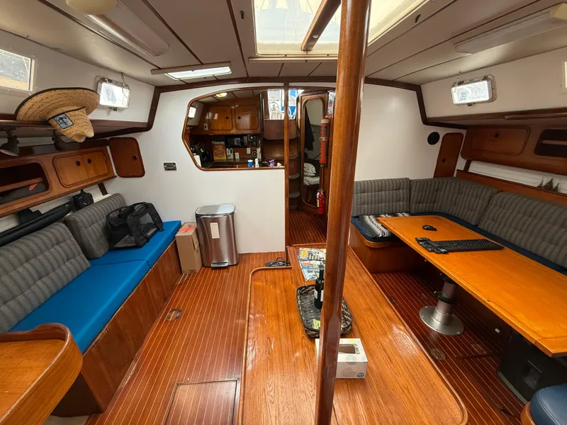 Slide: The Image of Interior of 1986 Beneteau Idylle 15.50 sailboat with wood finish and seating area. - 38