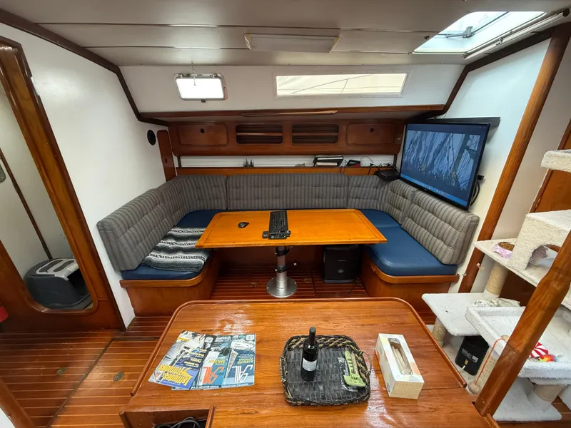 Slide: The Image of Interior of 1986 Beneteau Idylle 15.50 yacht with cozy seating and wooden table. - 39
