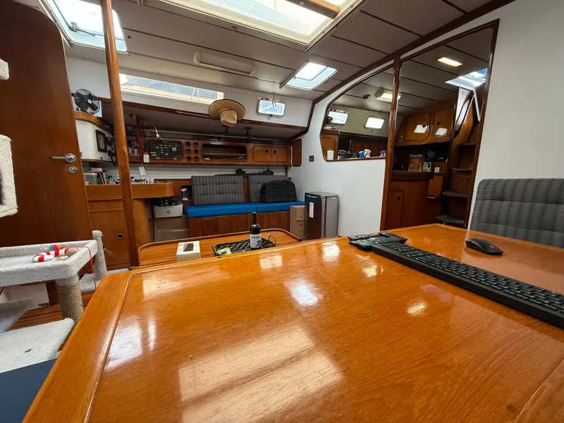 Slide: The Image of Interior of 1986 Beneteau Idylle 15.50 sailboat with wooden furnishings and seating area. - 40