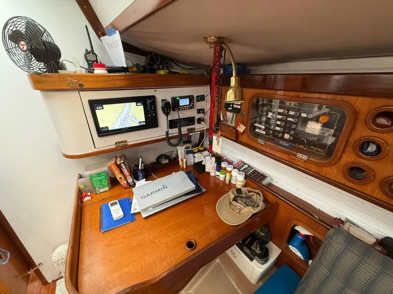 Slide: The Image of Navigation station on a 1986 Beneteau Idylle 15.50 yacht with equipment and charts. - 41