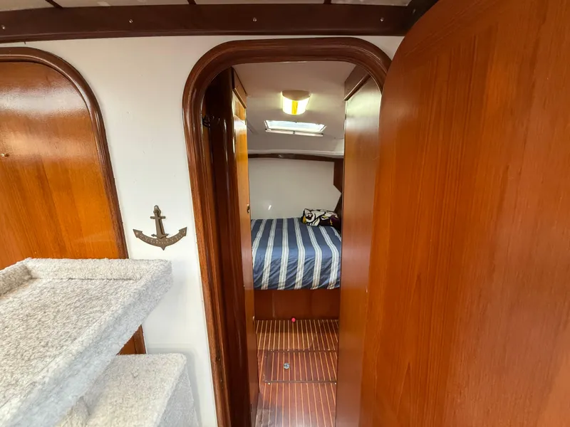 Slide: The Image of Interior of 1986 Beneteau Idylle 15.50 yacht with wood paneling and cozy cabin. - 43