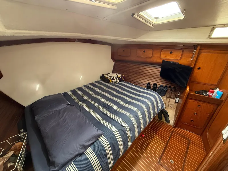 Slide: The Image of Cozy cabin interior of 1986 Beneteau Idylle 15.50 with striped bedding and wooden accents. - 45