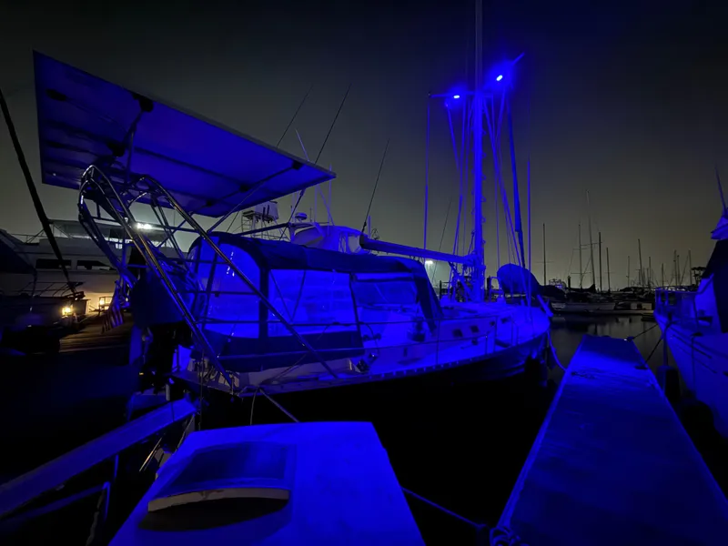 Slide: The Image of Sailboat Beneteau Idylle 15.50, 1986 model, illuminated at night in marina. - 5